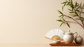 Elegant tea set with bamboo and fan displayed on a minimalistic table in a serene indoor setting photo