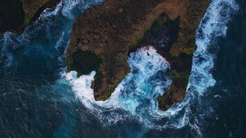 Waves crashing on the rocky shore, drone view from above video