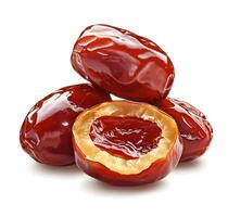 Close-up of red dates, one halved, on white background photo