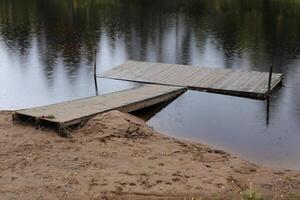 Small landing stage on a lake in Dalarna, Sweden, on a rainy day photo
