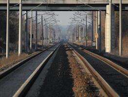 Symmetrical shot from the middle of two rail tracks photo