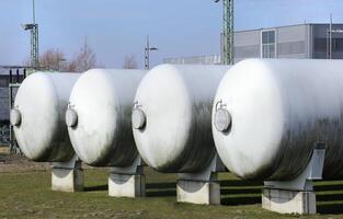 Four industrial gas tanks in a row photo