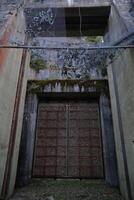 Entrance to a ruined Swedish railway bunker from WWII photo