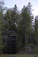 Entrance to a ruined Swedish railway bunker from WWII photo