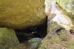 HDR image of cave under a big rock in Sweden photo