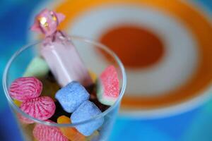 Glass with some different colorful Swedish sweets photo