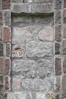 Stone wall with slot to insert e.g. a plate photo