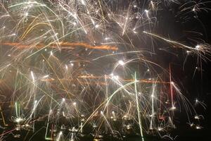 Long exposure shot of fireworks in different directions photo