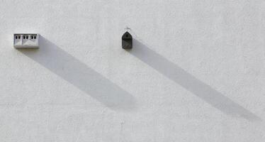 Different nest boxes installed on a house wall photo