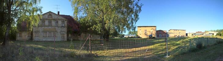 Panoramic view of desolate rural estate in Klein Kiesow, Germany photo