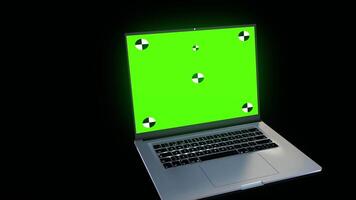 A laptop computer with a green screen on it video