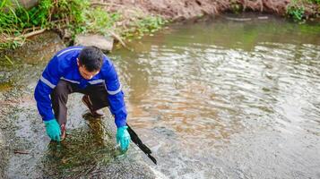 Water resource engineers check the purity of water flowing through pipes from natural water sources by collecting water samples for testing. photo