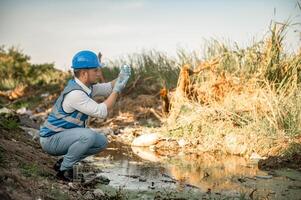 Water resources engineers inspect the quality of a canal in a community filled with garbage. photo