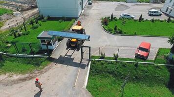 Machine on construction site. Aerial view of worker and heavy machine working at construction site video