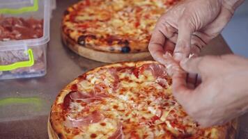 Chef making pizza. Baker hands placing ingredients on pizza video