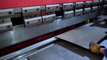 Sheet metal bending in factory. Metal sheet in workshop during manufacturing process video