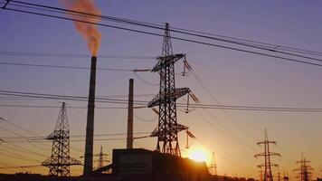 Electricity pylons and lines at dusk. Silhouette of high voltage tower and wires video