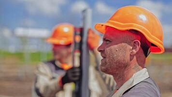 Engineers installing solar panels frame. Portrait of construction workers on site video