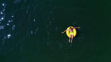 Boy swimming on pool ring. Top down view of boy floating on swim ring video