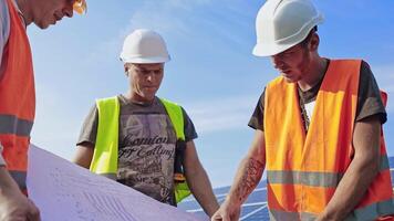 Engineers with solar panels project. Engineers and workers inspecting solar cells video