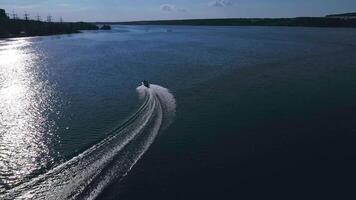 Boat with people floating on river. Aerial drone shot of sailing motor ship in the middle of river video
