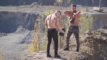 Man training with dumbbells. Muscular men exercising with dumbbell video