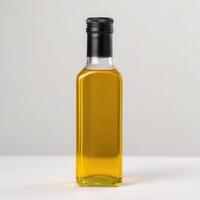 A bottle of golden cooking oil stands on a white surface photo