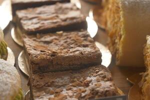 An array of pastries and eclairs are presented in the bakery display case with allure photo