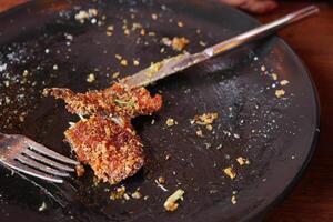 An empty dirty plate with a fork. photo