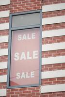 A Bright and EyeCatching Sale Sign Positioned in the Retail Window photo