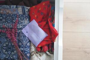 A Collection of Colorful Textiles and Accessories Neatly Stored in a Drawer photo