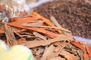 A Pile of Fresh and Aromatic Cinnamon Bark Along with Various Spices photo