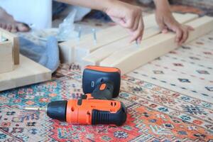 Engaging in a DIY home project using various power tools and wooden planks photo