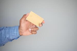 Man in casual dress showing credit card photo