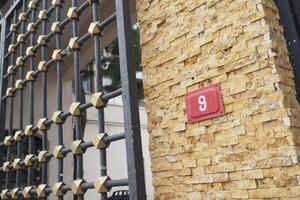 An Elegant Gate Design Complemented by a Number 9 House Sign Display photo