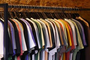 A Diverse Array of Colorful TShirts Neatly Hanging on a Rack for Display photo