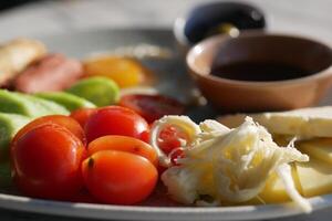 Fresh Mediterranean Platter with Tomatoes, Cheese, and Olives photo