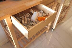 A Disordered Medicine Drawer Containing Various Pills, Packaging, and Additional Items photo