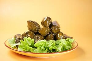 Traditional dolma grape leaves on a plate photo