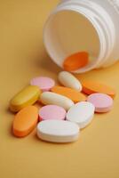An Array of Assorted Vitamins and Medications Displayed on a Bright Yellow Surface photo