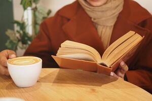A person is reading a book in a cozy and inviting setting that radiates warmth and comfort photo