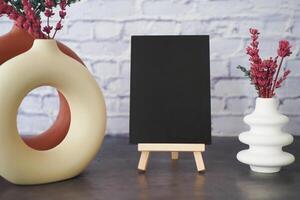 A Stylish Display Featuring a Black Canvas Backdrop and Decorative Vases photo