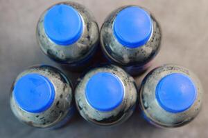 An Overhead View of Bottles Featuring Striking Blue Caps and More photo