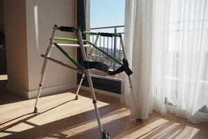 A Stylish Walker Positioned by a Window, Bathed in Natural Sunlight photo