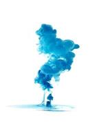 Blue ink dropped in to water isolated white background. Abstract color dissolving in water photo