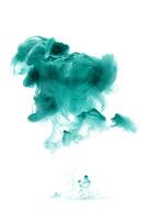 Green ink dropped in to water isolated white background. Abstract color dissolving in water photo