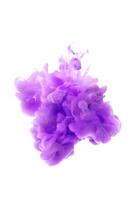 Purple ink dropped in to water isolated white background. Abstract color dissolving in water photo