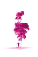 Pink ink dropped in to water isolated white background. Abstract color dissolving in water photo