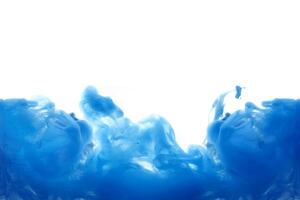 Blue ink dropped in to water isolated white background. Abstract color dissolving in water photo