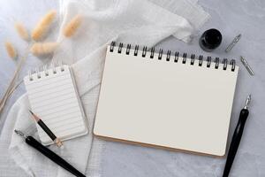 Blank book and note with dip pen on stone texture background. photo